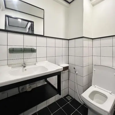 a white bathroom with a sink and a toilet at Years 1981 in Bangkok