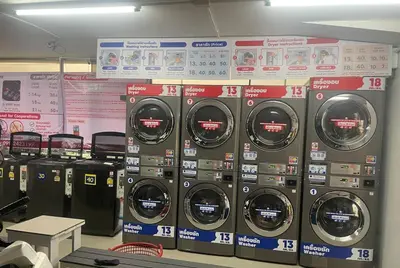 a row of washing machines in a store at Apartment studio at platinum in Bangkok
