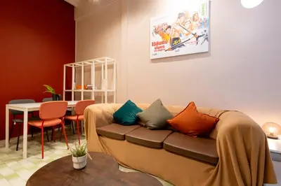 a living room with a couch and a table at Siam Twin Charoenkrung in Bangkok