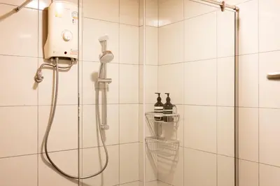 a shower with a shower head in a bathroom at Siam Twin Charoenkrung in Bangkok
