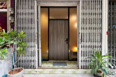 a front door of a building with plants at Siam Twin Charoenkrung in Bangkok