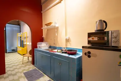 a kitchen with a sink and a refrigerator at Siam Twin Charoenkrung in Bangkok