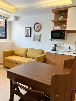 a living room with a couch and a table at Brix26 in Bangkok