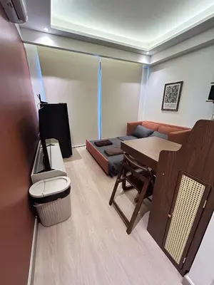 a living room with a table and a couch at Brix26 in Bangkok