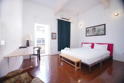 a bedroom with a bed and a table and a desk at XX Mitr Inn Yaowarat - China Town in Bangkok