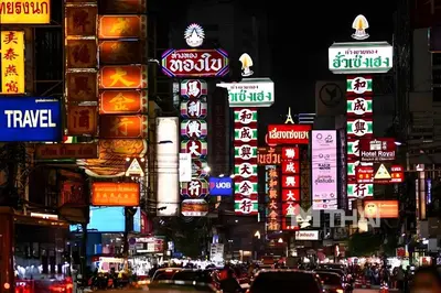 a busy city street at night with many signs at XX Mitr Inn Yaowarat - China Town in Bangkok