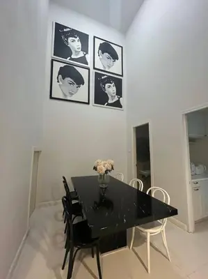 a dining room with a black table and chairs at Townhome 3 bed4 Baht Asok MRTBTS Sukhumvit 16 in Bangkok