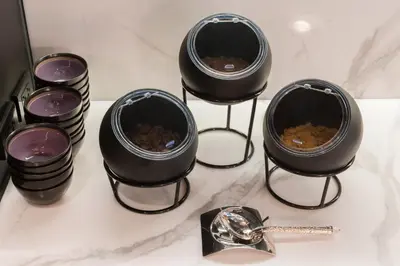 a group of black containers sitting on a counter at Skye Hotel Bangkok in Bangkok