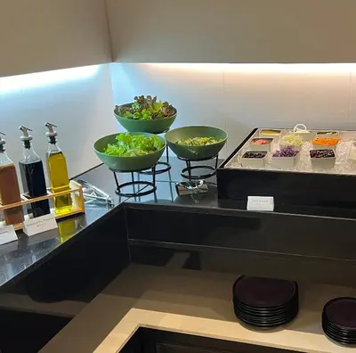 a buffet with three bowls of food on a counter at Skye Hotel Bangkok in Bangkok