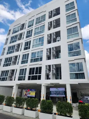 a large white building with balconies at Komfy Quarters in Sathani Bang Khen