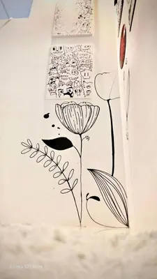 a drawing of a flower on a wall at 89 Bed & Studio Hostel in Godown