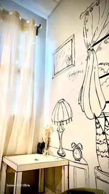 a room with a wall with a drawing of a lamp at 89 Bed & Studio Hostel in Godown
