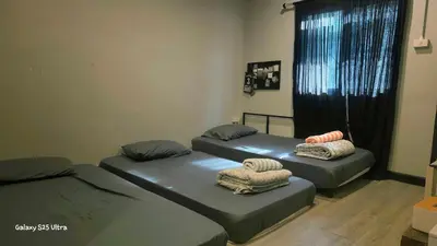 a room with two beds and a window at 89 Bed & Studio Hostel in Godown