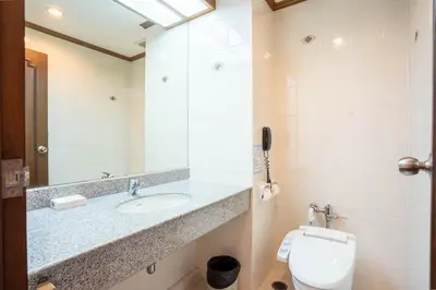 a bathroom with a sink and a toilet at Journeyhub Sukhumvit 26, Bangkok - Formerly St James Hotel in Bangkok