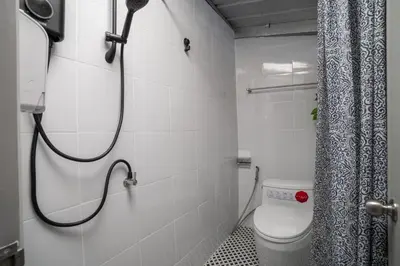 a bathroom with a shower and a toilet in it at Baan Apak Wat Arun in Bangkok Noi