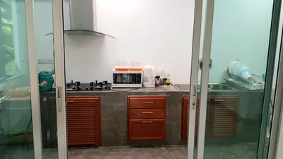 a kitchen with a sink and a microwave at Nido house in Ban Bang Phang