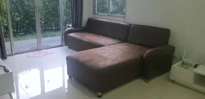 a brown leather couch in a living room at Nido house in Ban Bang Phang