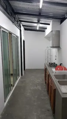 a kitchen with a counter and a sink in a room at Nido house in Ban Bang Phang