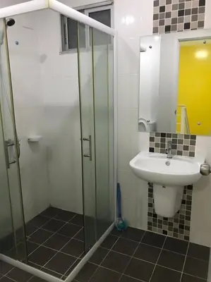 a bathroom with a sink and a glass shower at Nido house in Ban Bang Phang