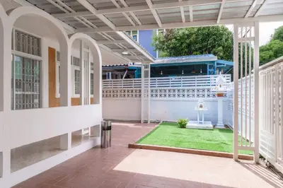 a balcony with a cruise ship in the background at Huai Khwang Cozy Home Comforts in Bangkok