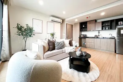 a living room with a couch and a table at The Gallery Bearing in Samut Prakan