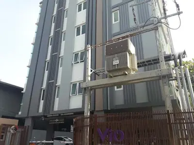 a building with a building with a sign on it at Thaiphil Condo in Nonthaburi