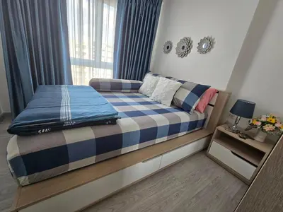 a small bed in a room with a window at Thaiphil Condo in Nonthaburi