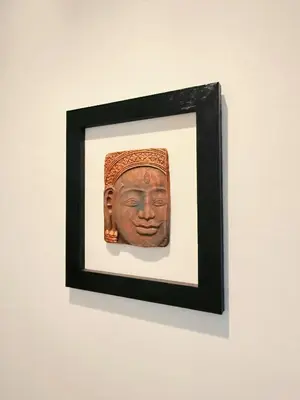 a framed picture of a head on a wall at Regalohome Bkk in Bangkok