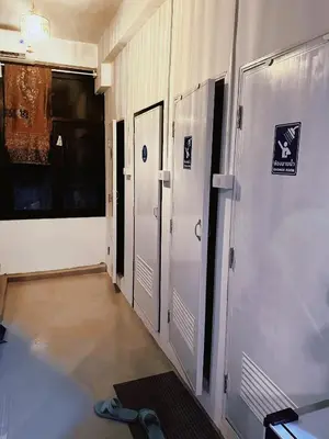 a hallway with four lockers in a building at Regalohome Bkk in Bangkok
