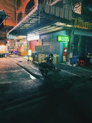 a motorcycle parked in front of a gas station at Regalohome Bkk in Bangkok