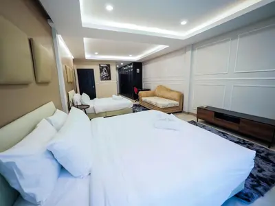 a bedroom with a large bed with white pillows at Oliver's House KS in Ban Yang