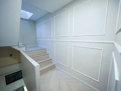 a white room with stairs and a door at Oliver's House KS in Ban Yang