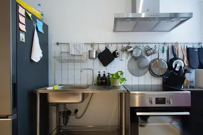 a kitchen with a sink and a stove at Dear Sunday Hometel Bangkok in Bangkok