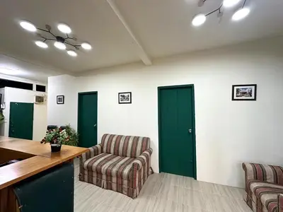 a living room with two chairs and a table at Atlas Hostel Khaosan in Bangkok