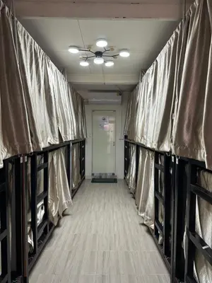 a row of baseball racks in a locker room at Atlas Hostel Khaosan in Bangkok
