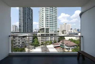 a room with a large window with a view of a city at Bangkok Feliz Sukumvit69 in Bangkok