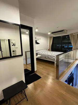 a room with a bed and a balcony with a mirror at Bangkok Feliz Sukumvit69 in Bangkok