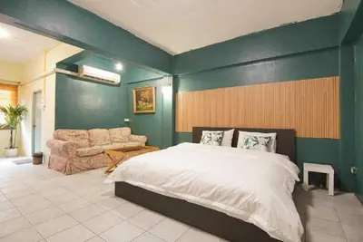 a bedroom with a large bed and a couch at XX GO INN The Grand Palace I โกอินน์ พระบรมมหาราชวัง in Bangkok