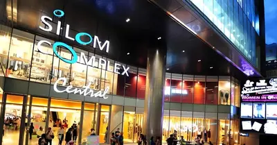 a store front of a shopping mall at night at GO INN Silom BTS Surasak สถานีสุรศักดิ์ in Bangkok