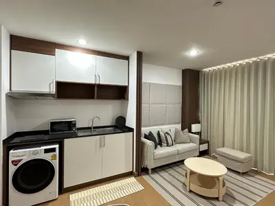 a kitchen and living room with a washer and dryer at 6th Avenue Sukhumvit BKK 302 BTS Asoke & Nana MRT Sukhumvit in Bangkok