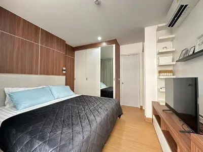 a bedroom with a bed and a flat screen tv at 6th Avenue Sukhumvit BKK 302 BTS Asoke & Nana MRT Sukhumvit in Bangkok