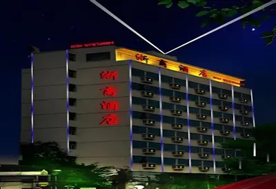 a hotel with red writing on the side of a building at Palette The Travellers Hotel Bangkok in Bangkok