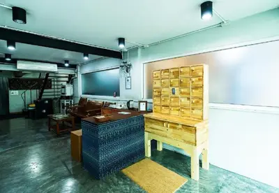 a room with a desk and a table in it at XX GO INN Khaosan BKK The Grand Palace - โกอินน์ ถนนข้าวสาร in Bang Bua Thong Railway Station