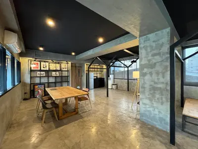 a dining room with a wooden table and chairs at Fellows House in Bangkok