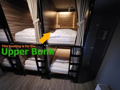 an overhead view of three bunk beds in a room at Fellows House in Bangkok