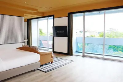 a hotel room with a bed and large windows at The Quarter Saphankhwai by UHG in Bangkok