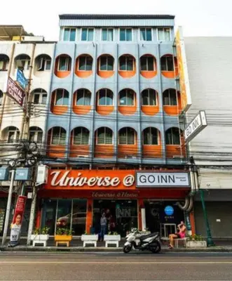 a large building with orange windows on a city street at XX GO INN Khaosan ข้าวสาร กรุงเทพมหานคร in Bangkok