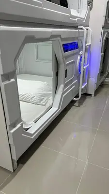 an empty hospital bed in a hospital room at Kiwi Capsule Hotel in Bangkok