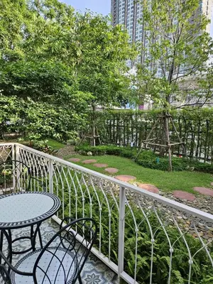 a balcony with a table and chairs and a fence at Dusita Residence in Bangkok