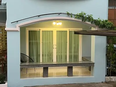 a building with a window with a table in it at Dusita Residence in Bangkok